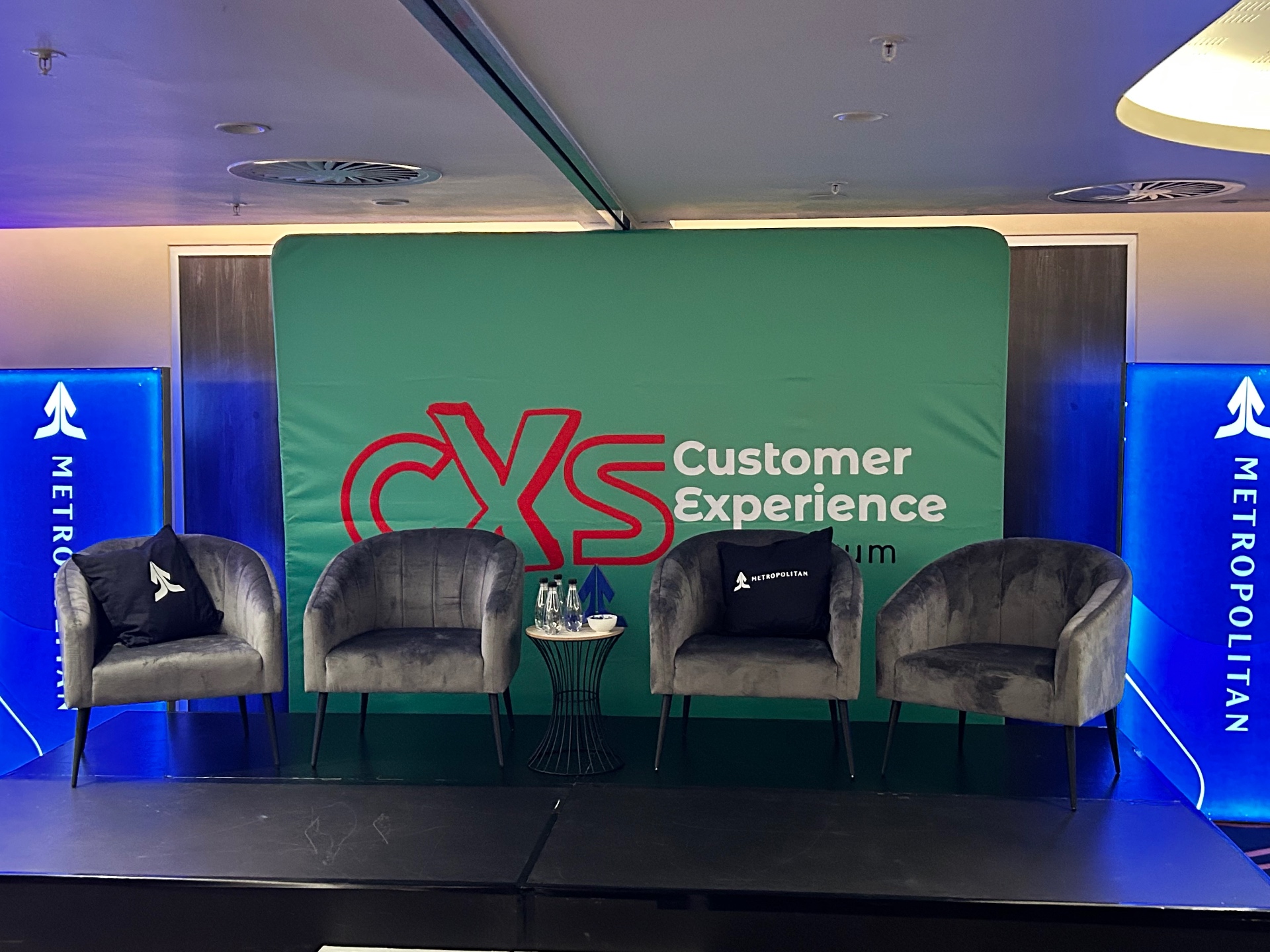 CXS branded main stage with panel seating
